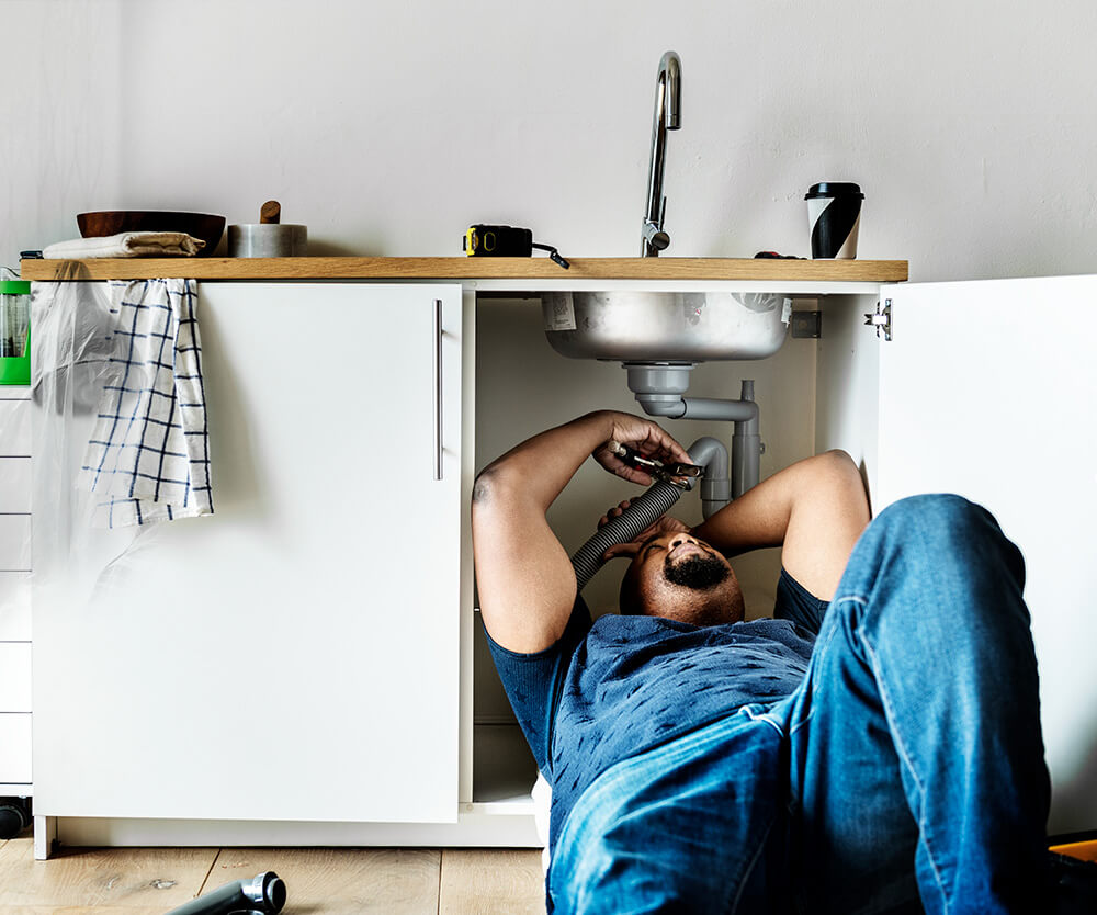 plumber fixing kitchen sink